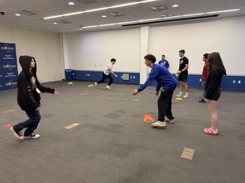 Students throwing bean bags