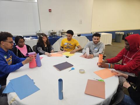 Students sitting around table doing work
