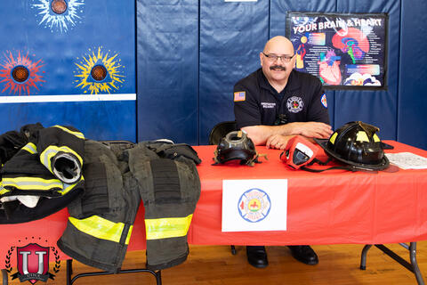 Firefighter posing with his career table