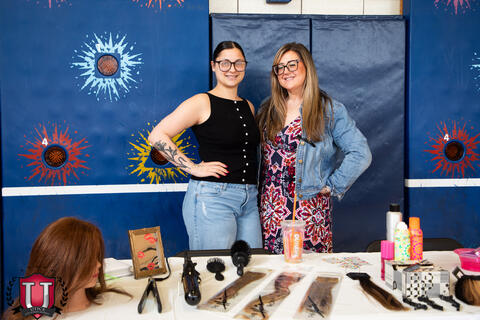 Two hairdressers posing with their career table