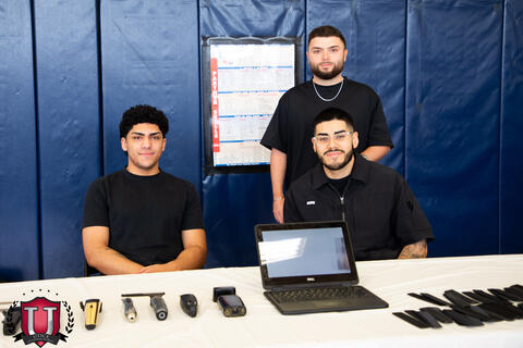 The barbers posing with their barber career table