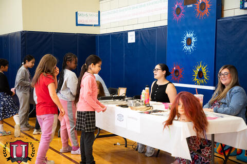 Shot from behind of students walking around the tables