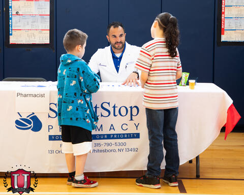 Students talking to the pharmacy table