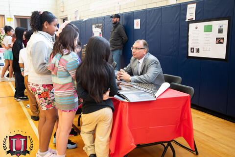 Students talking to the judge at his table