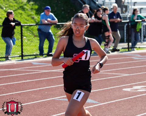 Athlete running with baton