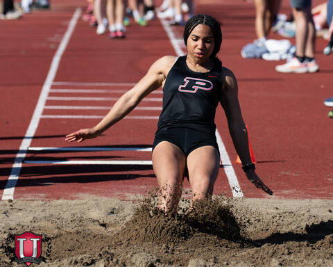 Athlete landing in the long jump sand pit