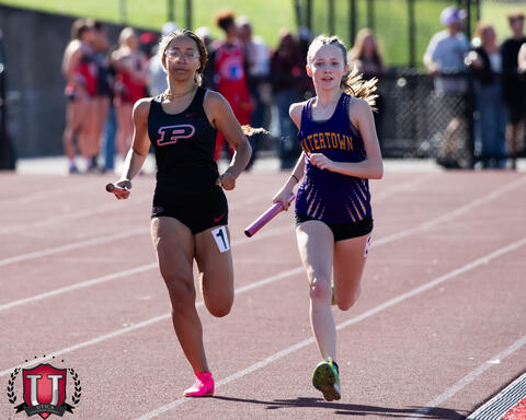 Two athletes running next to each other