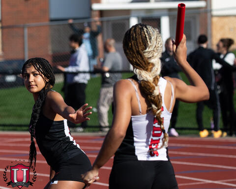 Athlete looks to throw baton to other runner