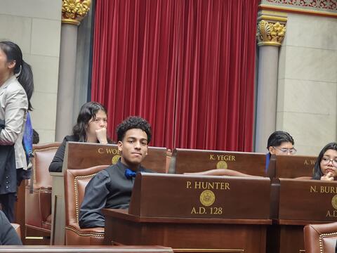 Student sitting in a mock assembly 
