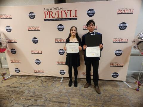 Students posing with their scholarship awards