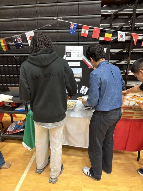 Students looking at a table display for culture