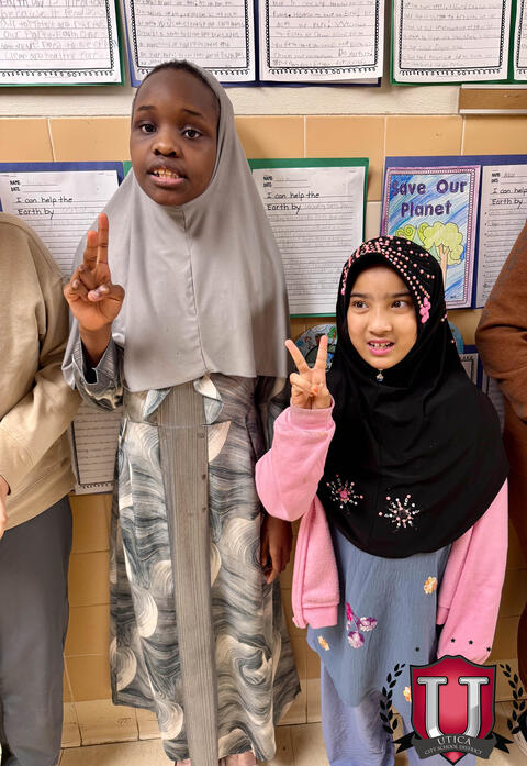 Students holding up the peace sign for earth day