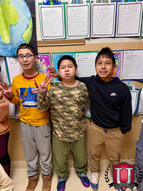 Three students all posing with the peace sign