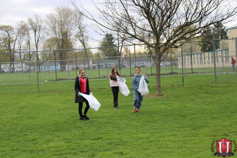 Students running around looking for trash