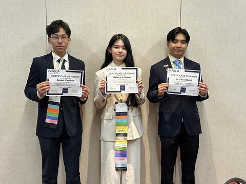 Students posing with their awards from the event