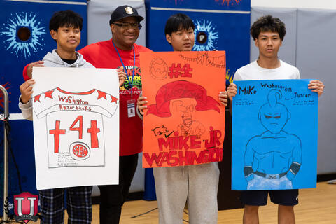Students posing with their posters