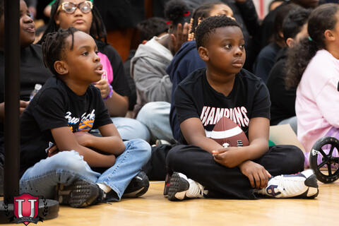 Students sitting down patiently listening