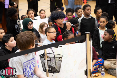 Student talking at a microphone