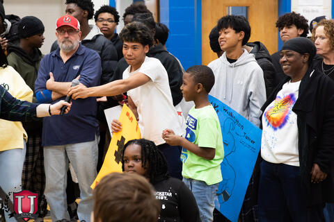 Student being handed a microphone