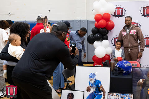 Student posing with mike