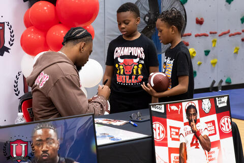 Mike signing something for a student