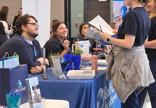 Student at a Health Career Fair booth.