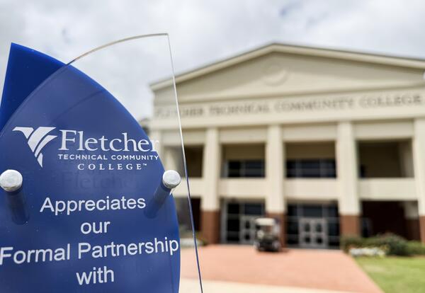 A Fletcher Technical Community College partnership recognition plaque is featured in front of the college’s main campus, symbolizing the strong and growing network of business and industry partnerships supporting workforce development in South Louisiana.