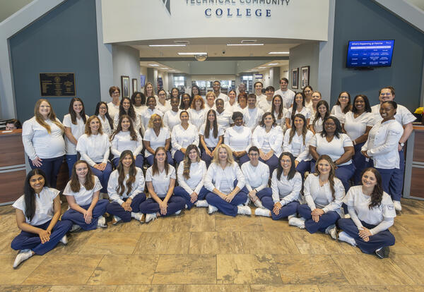 Group photo of Fletcher Technical Community College's Summer 2026 Associate of Science in Nursing graduates and faculty. The 52-student cohort, representing the traditional ASN and LPN-to-RN Bridge pathways, is the largest ASN graduating class in the coll