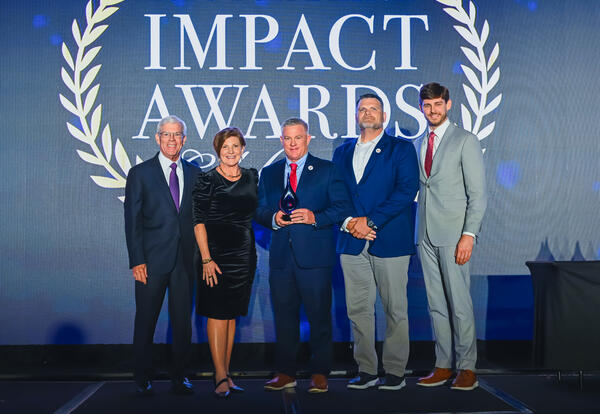 Joe May, Dr. Kristine Strickland, Charlie Burt, Garret Landry and Richard Nelson stand onstage at the LCTC Foundation Impact Awards. Burt holds the Joe D. May Excellence in Public Policy Award.