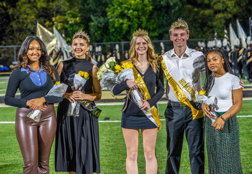 Current and former homecoming court members pose for a picture