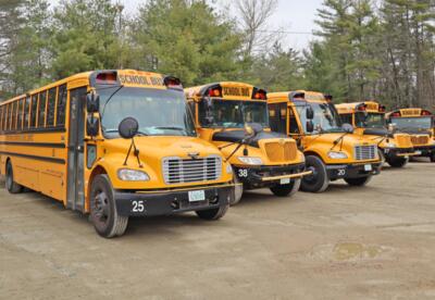 A photo showing five ORCSD yellow school buses.