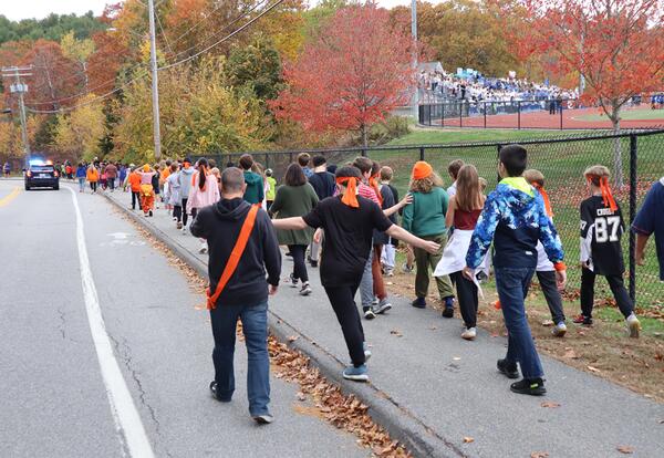 Group of ORMS students walking outside in a show of unity during the “Walk a Mile in Someone Else’s Shoes” event.