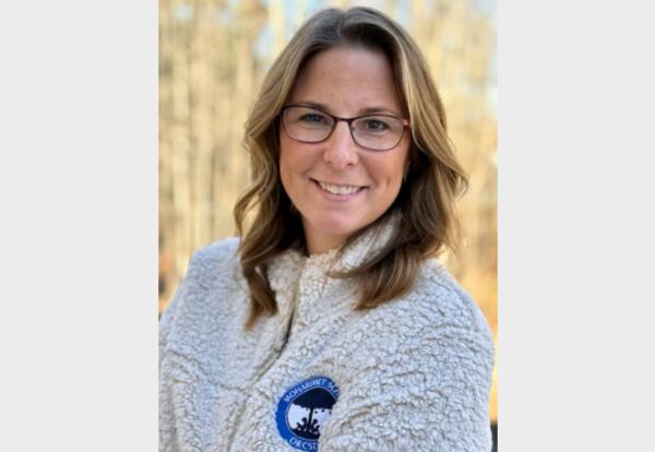 Jessica Whalen is seen smiling and wearing a Moharimet sweater.
