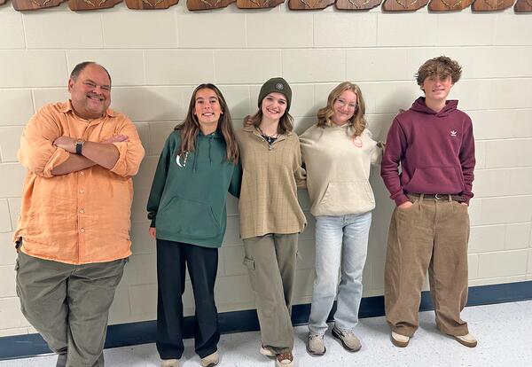 Music Teacher Marc LaForce is seen alongside four students.