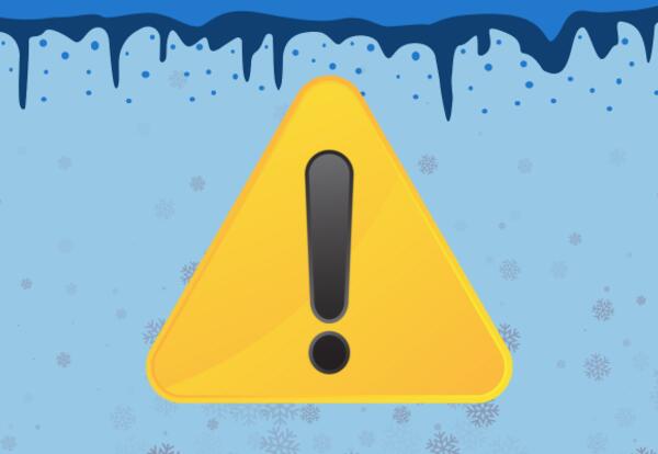 A yellow warning sign showing an exclamation point and snowflakes.