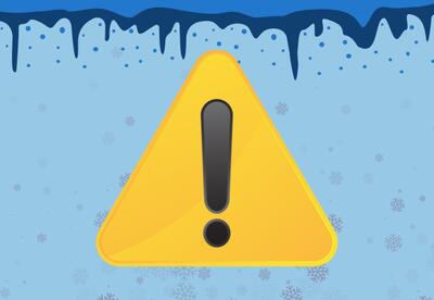 A yellow warning sign showing an exclamation point and snowflakes.