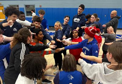 A photo showing high school and UNH students during a team building activity.