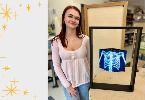 Senior Lilly Smith is pictured next to her mixed media piece, Heavy.