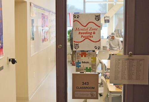 Sign reading “Mental Zone Reading and Puzzles” posted outside a classroom during Bobcat Community Day.