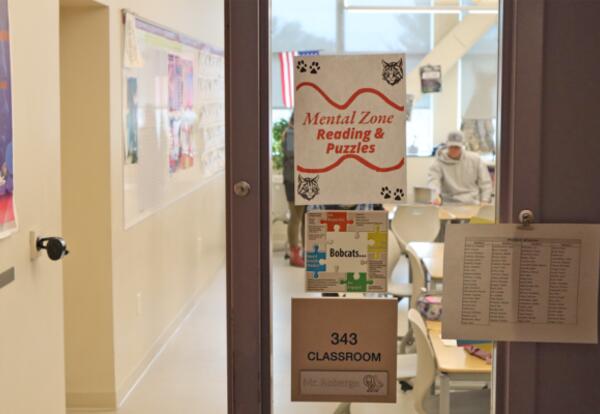 Sign reading “Mental Zone Reading and Puzzles” posted outside a classroom during Bobcat Community Day.