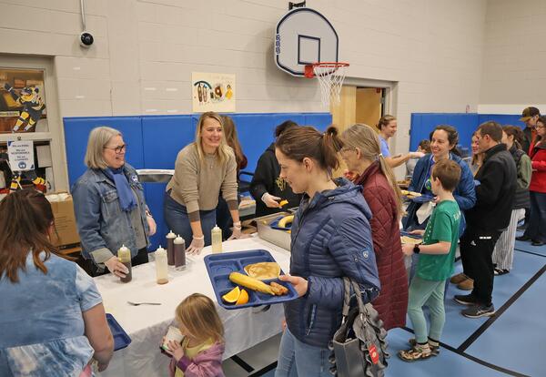 Families are served breakfast by volunteers during the 2026 Pancake Breakfast.