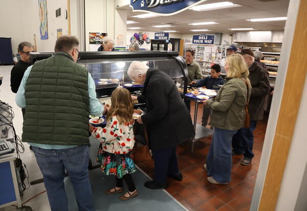 Community members at the salad bar during the April 22 community dinner.