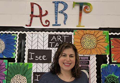 Woman under words that say "ART"