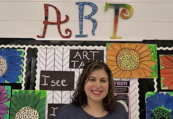 Woman under words that say "ART"