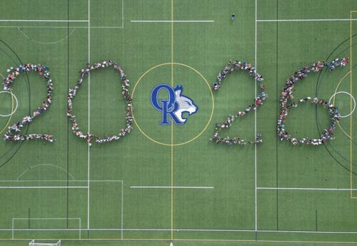 Aerial view of ORMS students standing on a turf field forming the numbers 2026