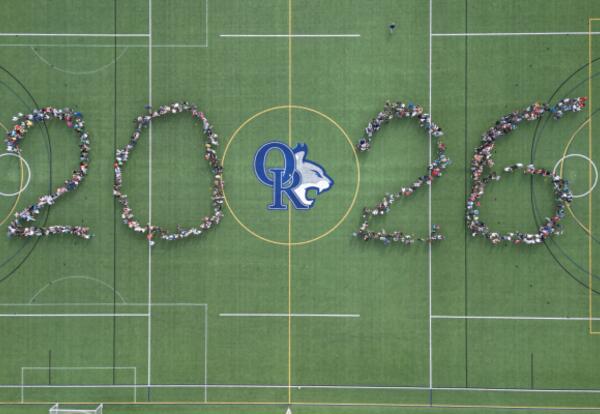 Aerial view of ORMS students standing on a turf field forming the numbers 2026