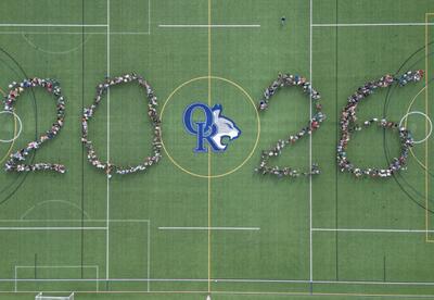 Aerial view of ORMS students standing on a turf field forming the numbers 2026