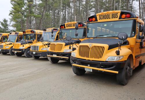 Picture of Oyster River bus fleet parked at the Transportation office.