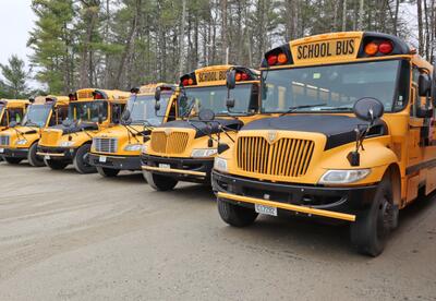 Picture of Oyster River bus fleet parked at the Transportation office.