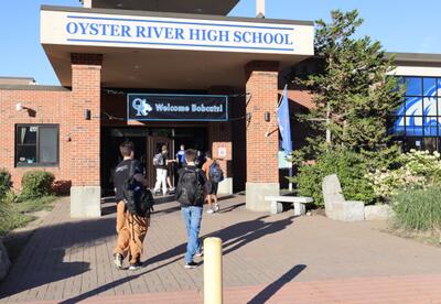Students enter Oyster River High School on the first day of school.